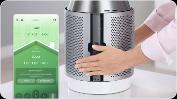 Owner fitting the filter shroud back onto their Dyson purifier with the MyDyson app reporting their air quality. Owner fitting the filter shroud back onto their Dyson purifier with the MyDyson app reporting their air quality.